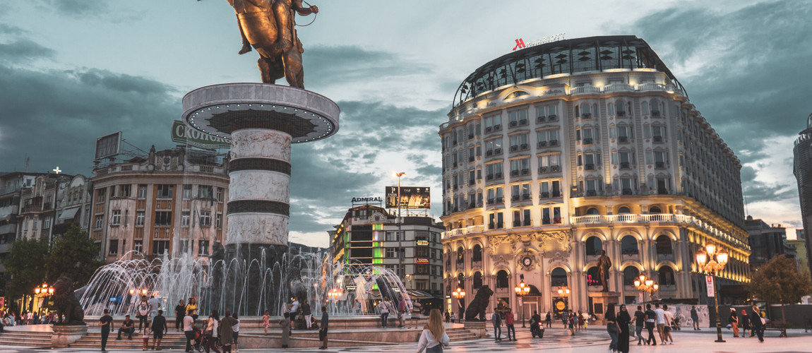 Macedonia Square in Skopje, featuring the statue of Alexander the Great and the Marriott Hotel in the background.