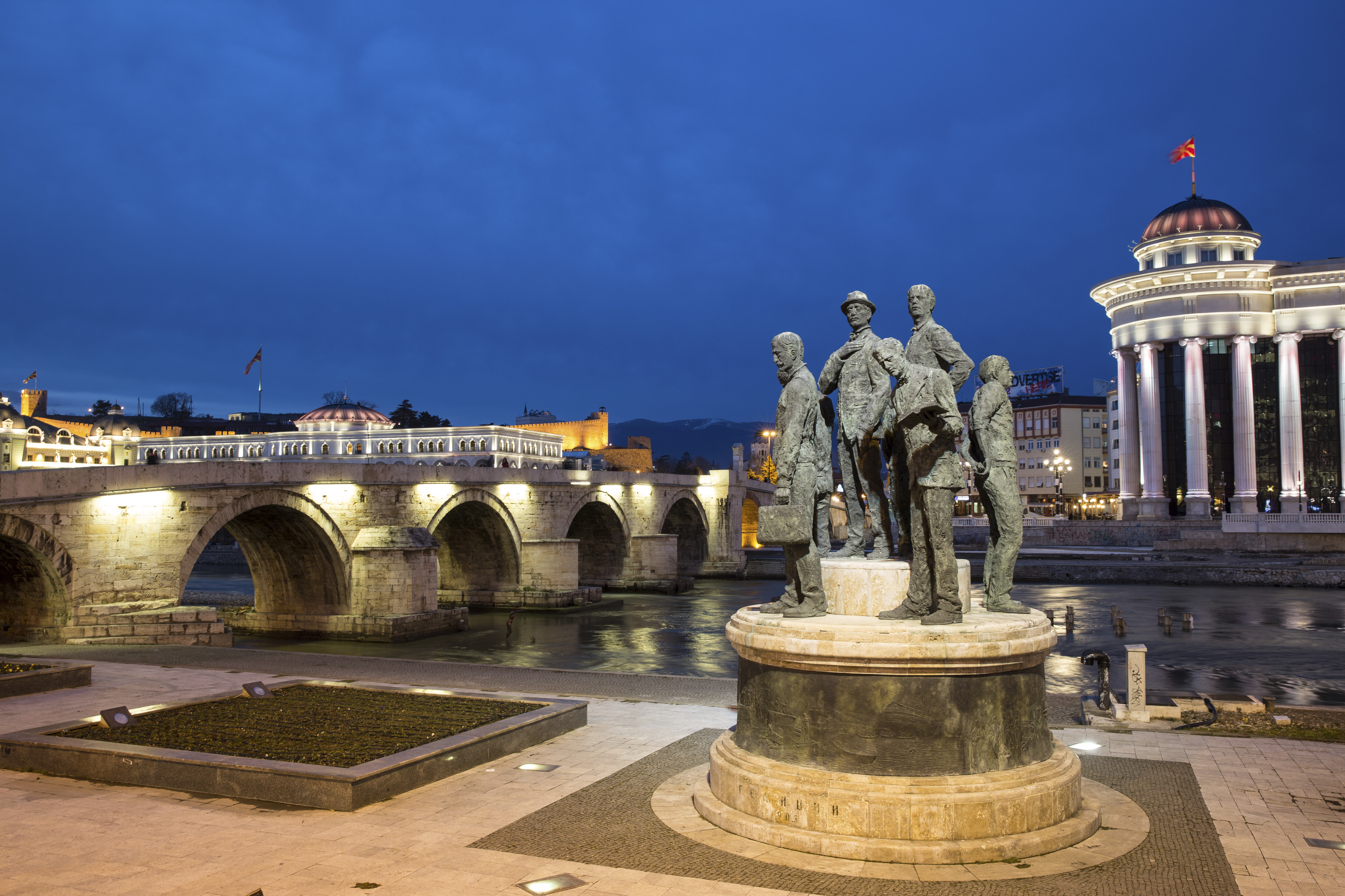 Old town bridge and cityscape at night - Skopje, North Macedonia