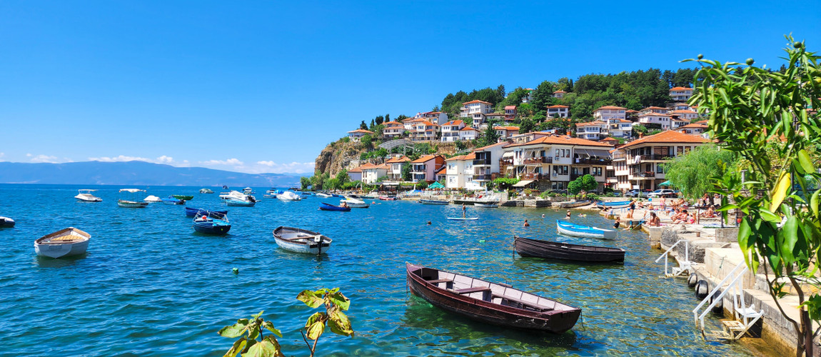 Lake Ohrid with crystal clear water and traditional houses along the shoreline