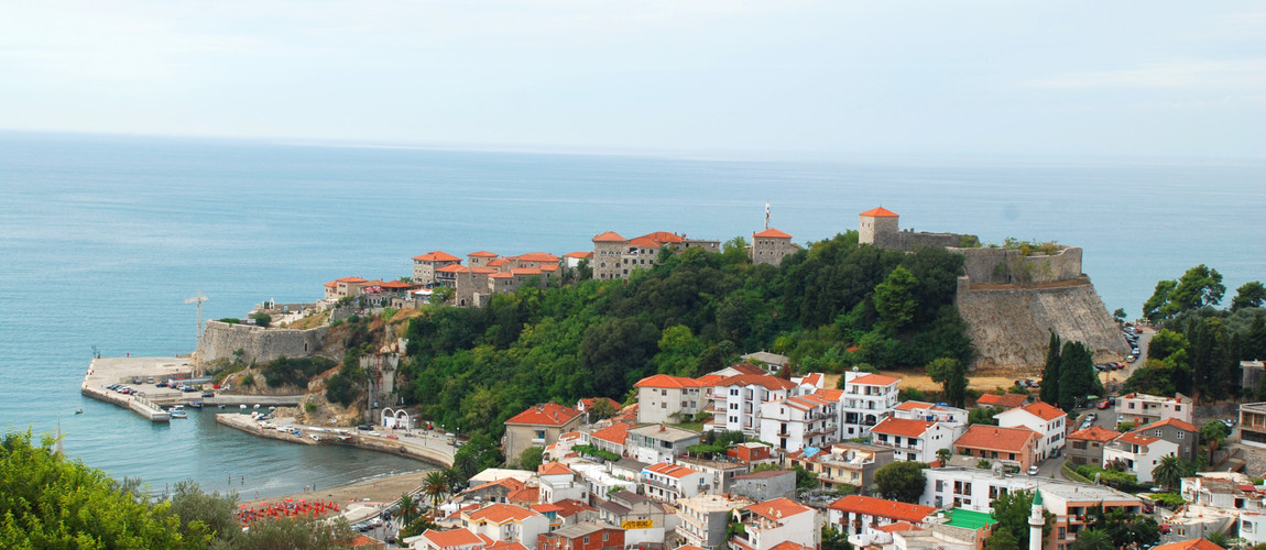 A stunning view of Ulcinj’s Old Town and fortress above the Adriatic Sea.