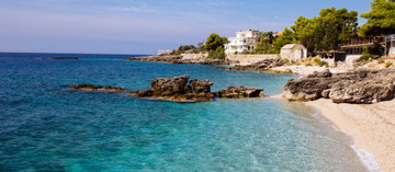 Dhërmi Beach, a gem of the Albanian Riviera with crystal-clear waters and breathtaking landscapes.