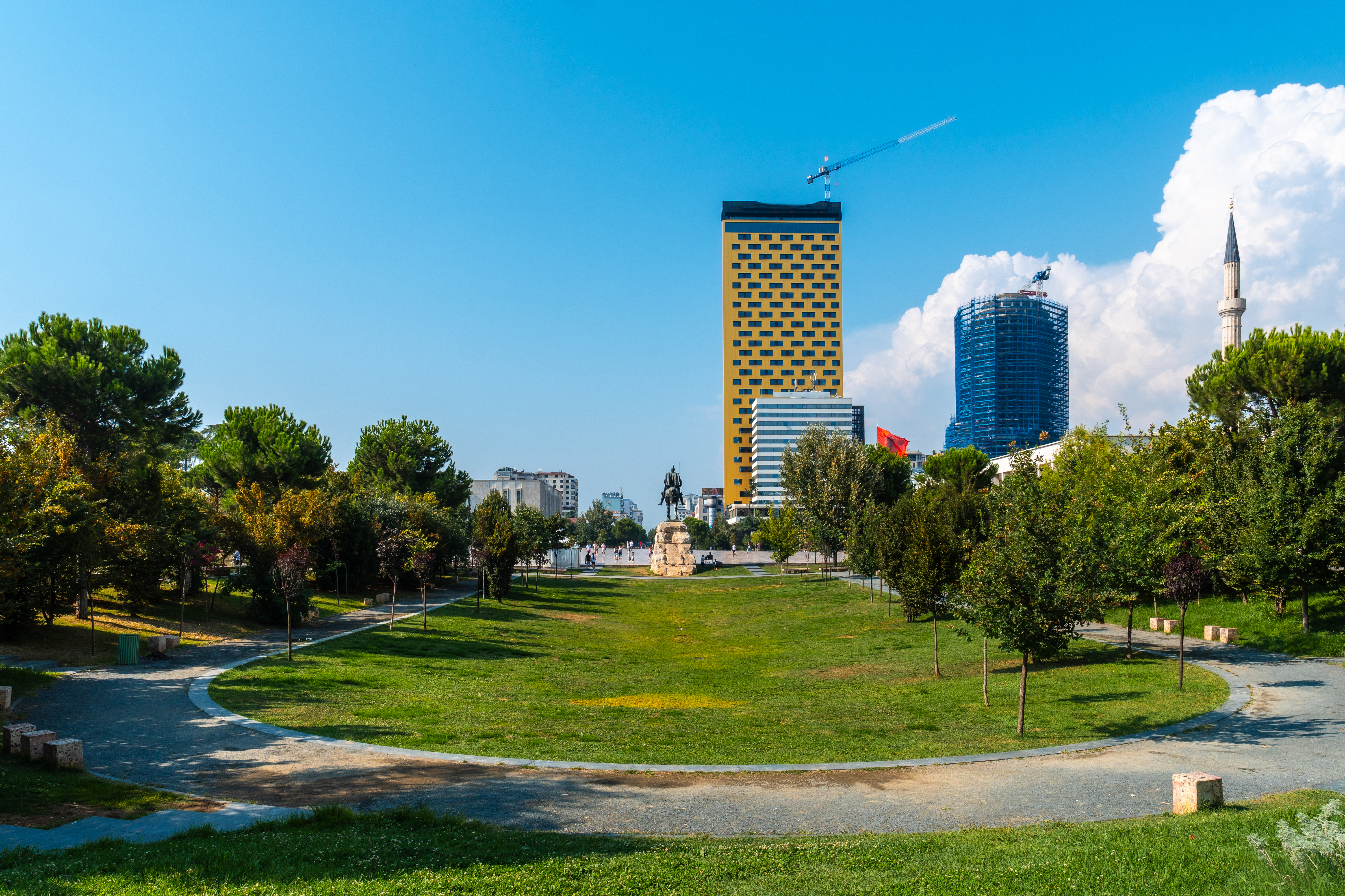 A large green park in Tirana with walking paths, and plenty of open space for relaxation.