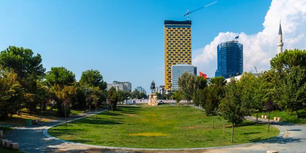 A large green park in Tirana with walking paths, and plenty of open space for relaxation.