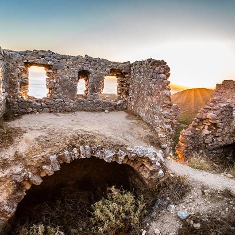 The ruins of Porto Palermo Castle, offering stunning sunset views over the Ionian Sea.
