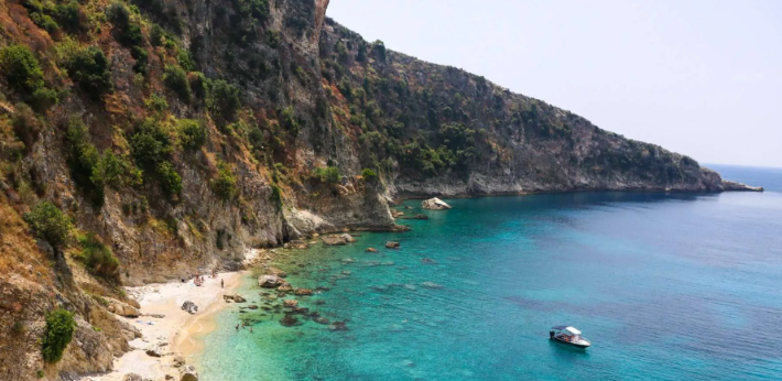 A hidden beach in Himara, surrounded by cliffs and crystal-clear waters, perfect for a peaceful escape