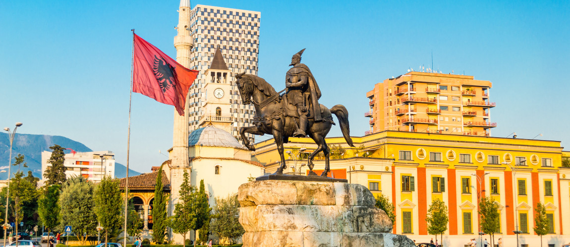 Skanderbeg Square in Tirana with the statue of the national hero and the Albanian flag.