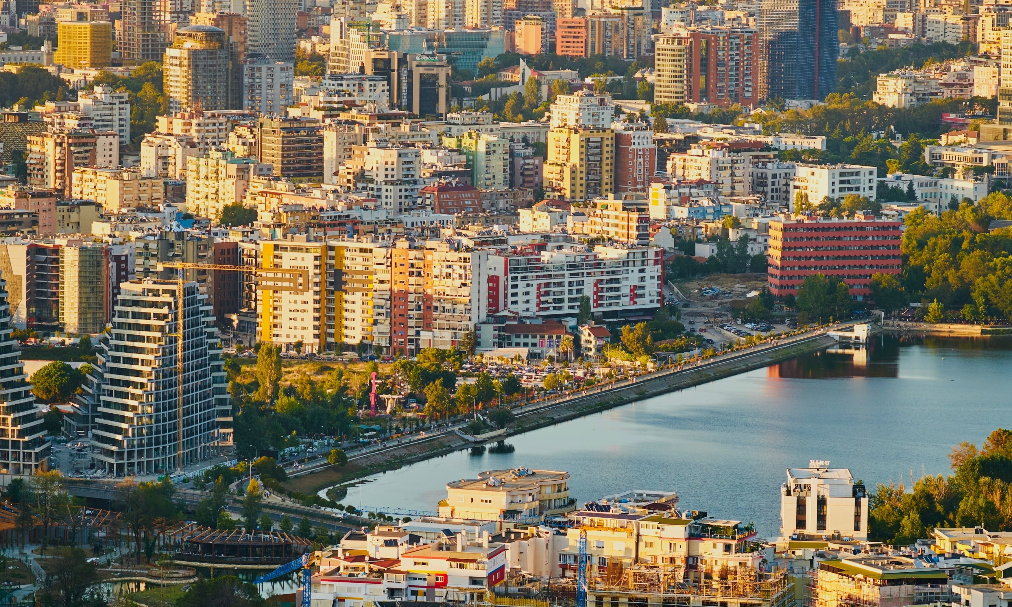 A view of Tirana with modern buildings and the city’s Artificial Lake.